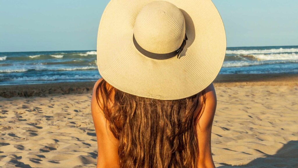 woman with long hair on a beach in the summer