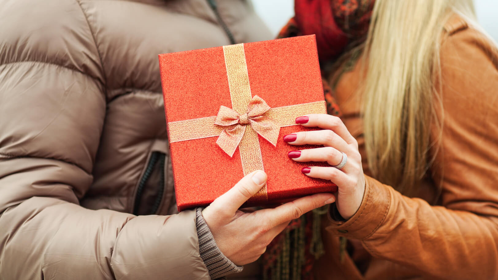 Closeup view of a couple holding a gift box